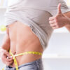 Man measuring waist after successful weight loss treatment in Palm Harbor FL