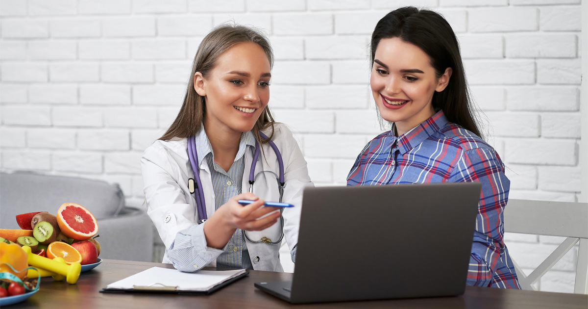 Doctor explaining injectable weight loss treatments and long-term weight management options to a patient