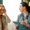 Older woman discussing hormone replacement therapy symptoms with a medical provider